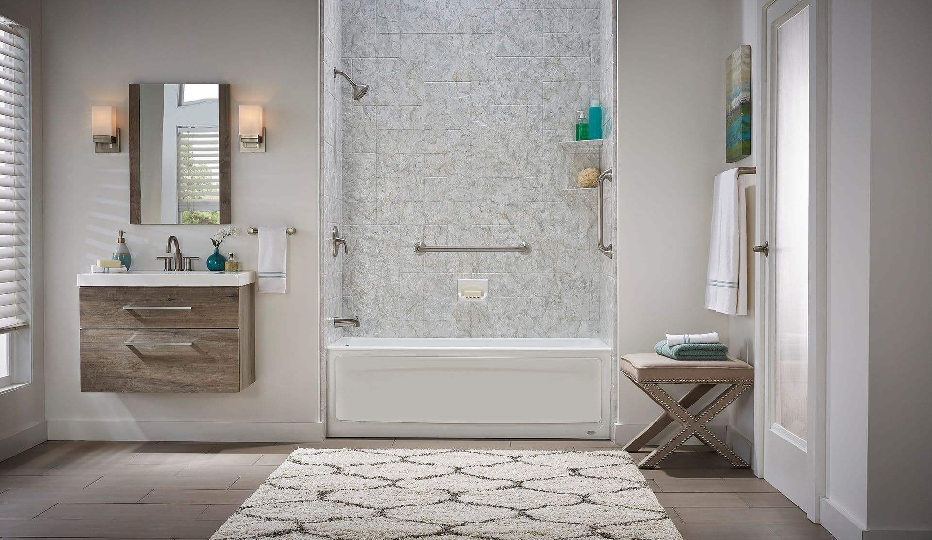 A combination shower bathtub with gray and white walls and a horizontal grab bar.
