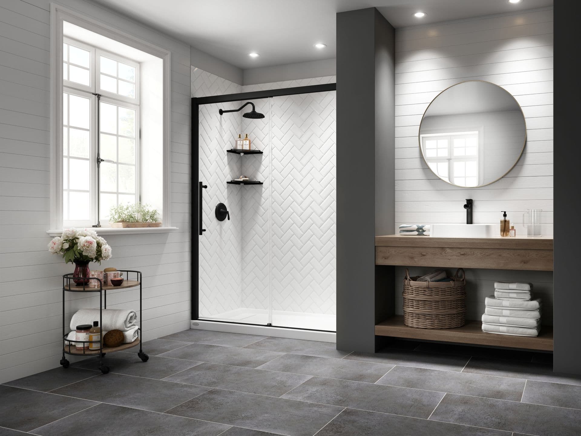 A walk-in shower with glass sliding doors and herringbone-style tile walls.